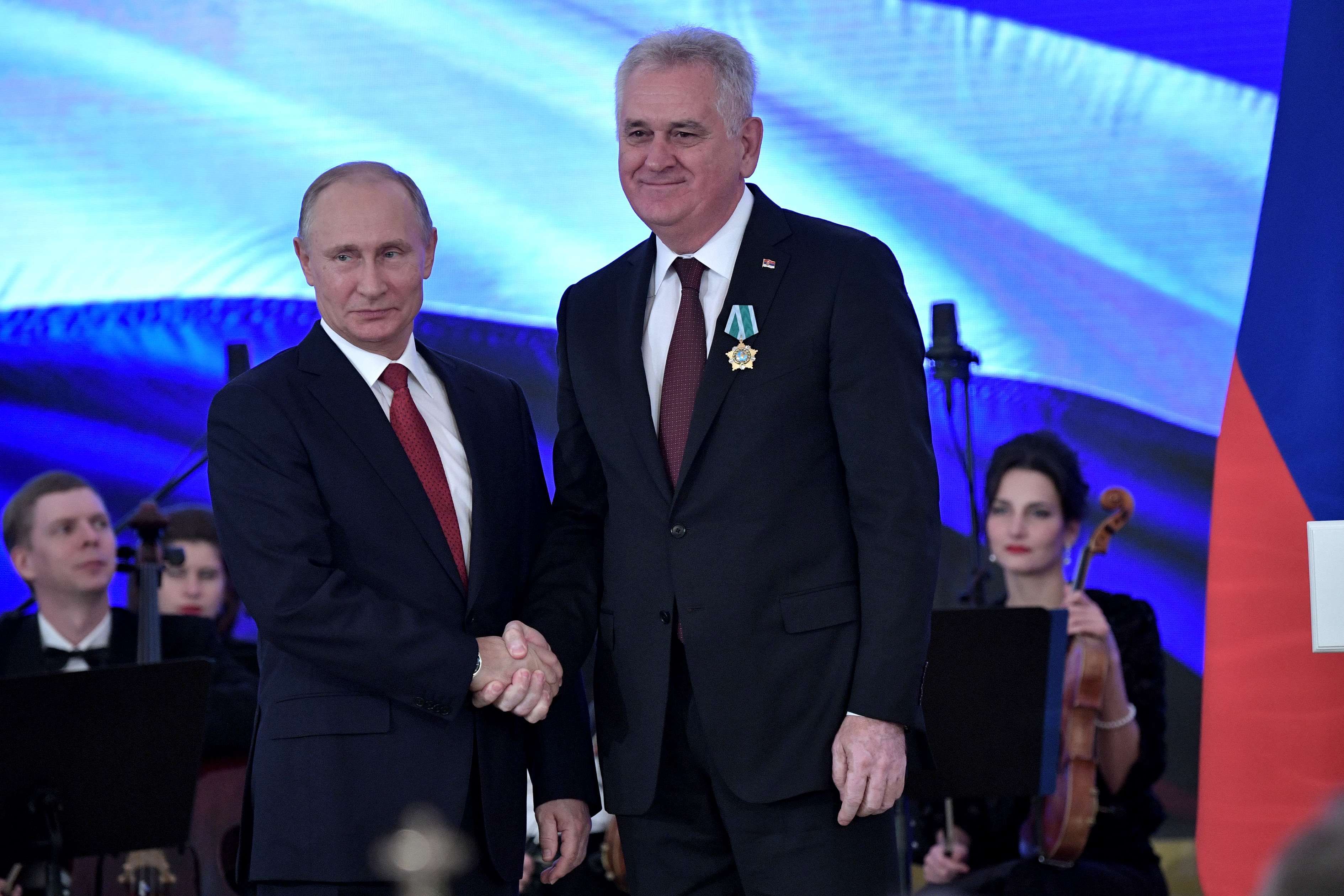 Russia’s President Putin decorates former President of Serbia and incumbent National Council President Tomislav Nikolić with Order of Friendship on the National Unity Day